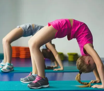 A group of young girls doing various exercises.